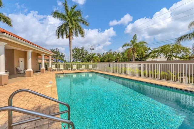 view of swimming pool with a patio area