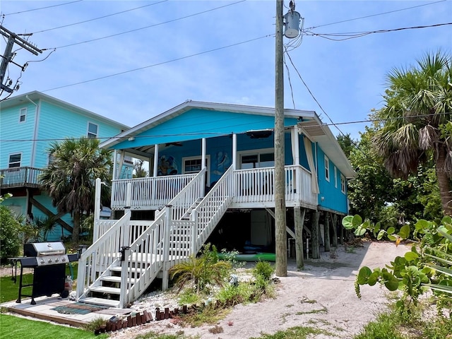 back of property featuring covered porch and a carport