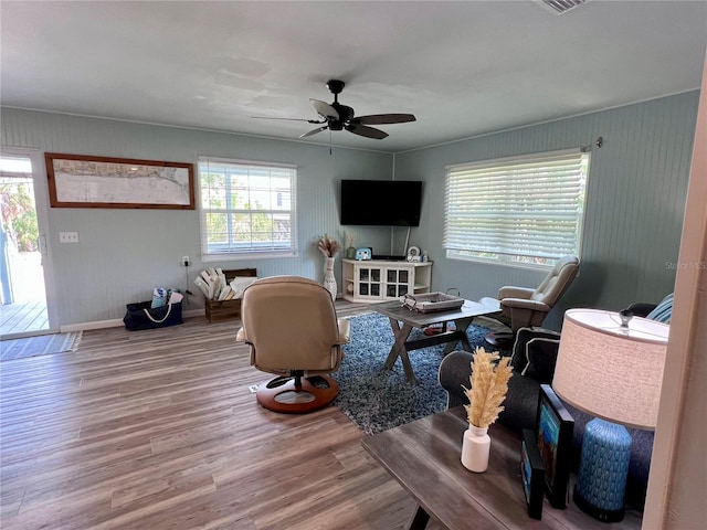 living room featuring a wealth of natural light, ceiling fan, and hardwood / wood-style floors