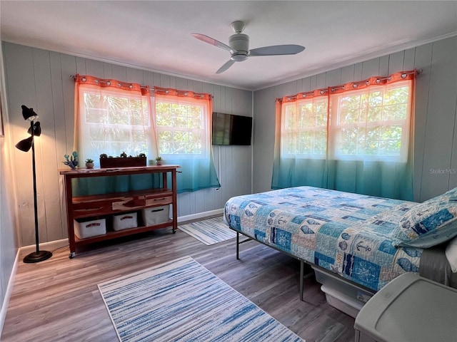 bedroom with wood-type flooring and ceiling fan