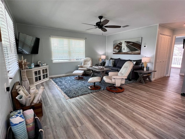 living room featuring ceiling fan and hardwood / wood-style flooring