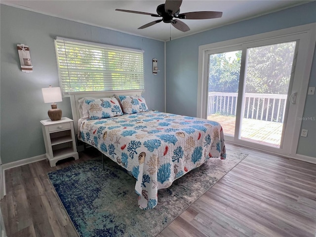 bedroom featuring access to outside, multiple windows, and hardwood / wood-style floors