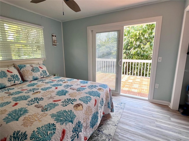 bedroom featuring hardwood / wood-style floors, ornamental molding, ceiling fan, and access to exterior