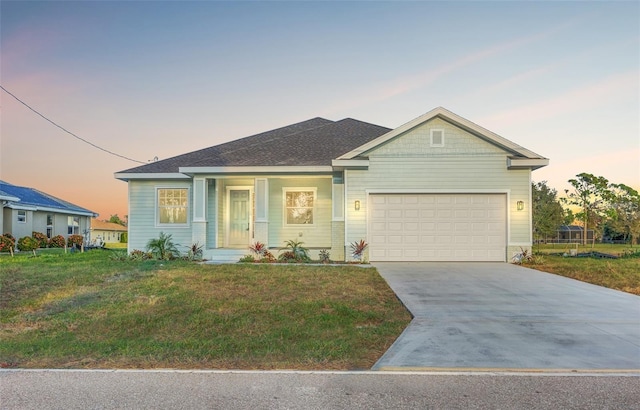 ranch-style house with a garage and a lawn