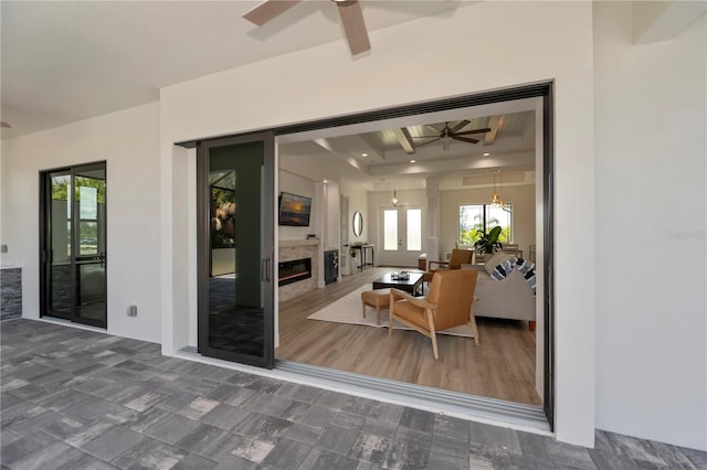 interior space with beamed ceiling and ceiling fan