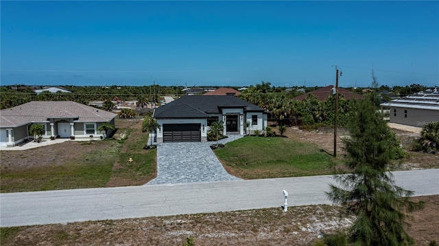 view of front of property with a garage and a front yard