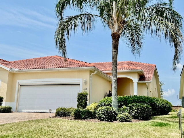 exterior space featuring a garage and a front lawn