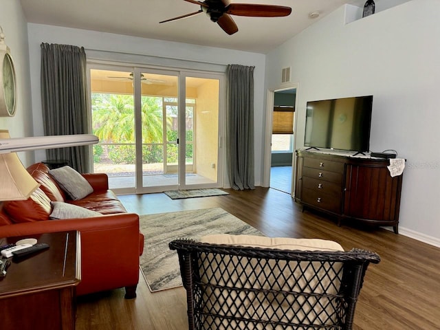 living room featuring plenty of natural light, ceiling fan, and dark hardwood / wood-style flooring