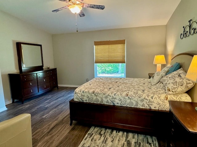 bedroom featuring ceiling fan, dark hardwood / wood-style floors, and lofted ceiling