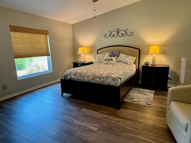 bedroom with dark hardwood / wood-style flooring