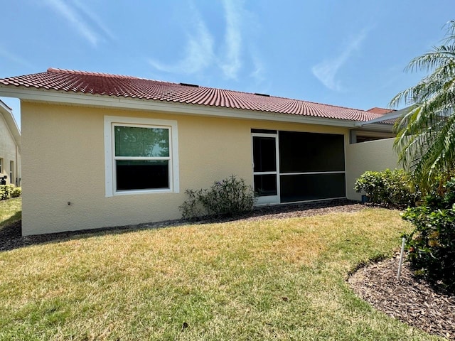 rear view of house featuring a lawn