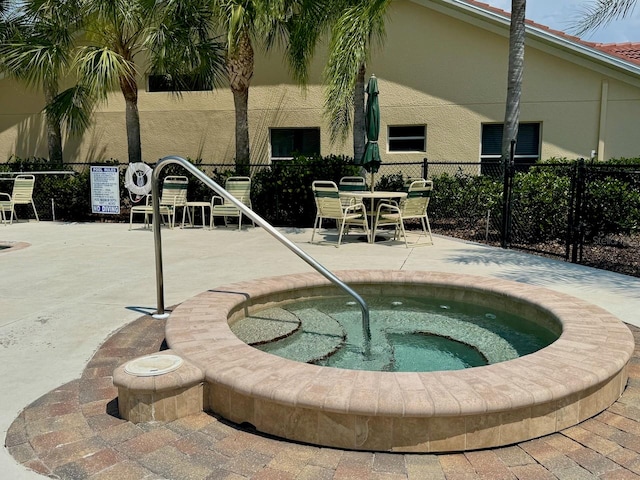 view of swimming pool featuring a community hot tub and a patio area