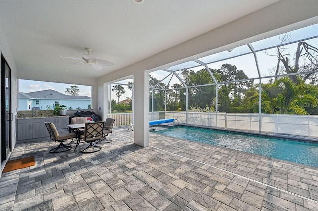 view of swimming pool featuring a patio area, ceiling fan, and a lanai