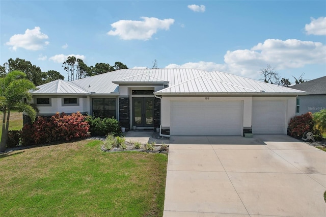 ranch-style home featuring a garage and a front lawn