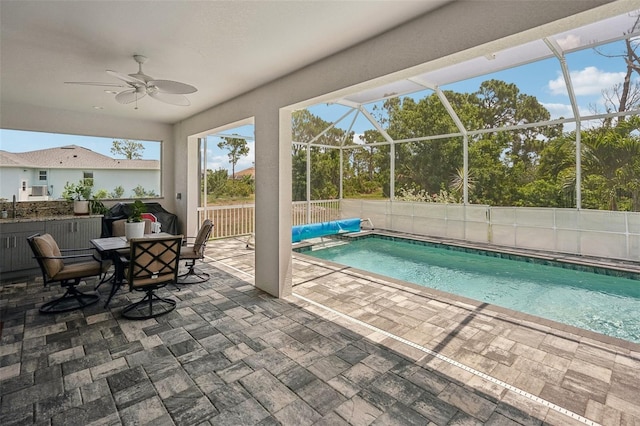 view of pool featuring a patio area, ceiling fan, a lanai, and sink