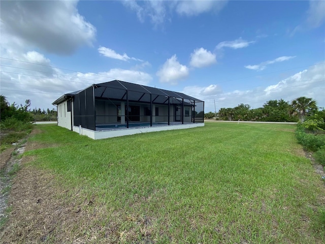 back of property with a lawn and glass enclosure