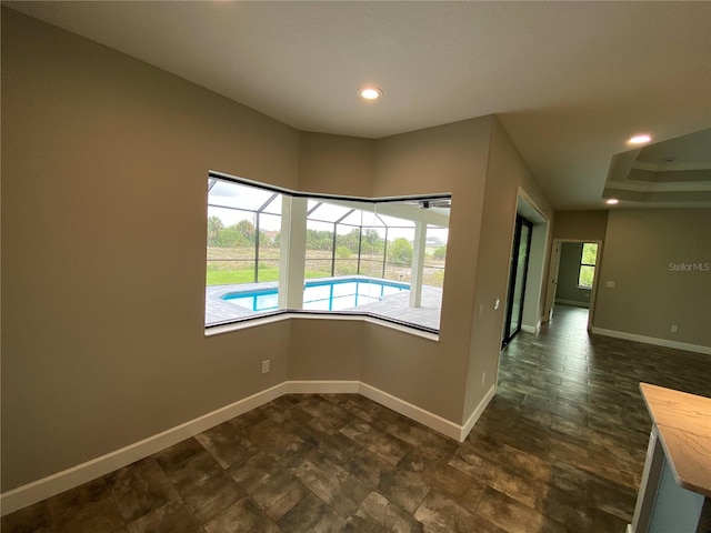 unfurnished room featuring dark tile floors