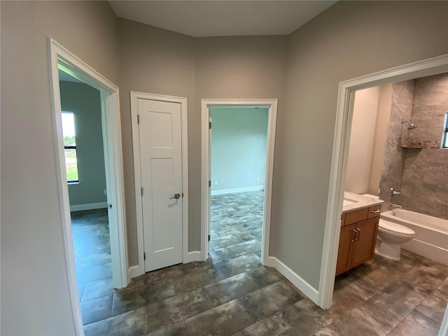 full bathroom featuring tile floors, vanity, and tiled shower / bath combo