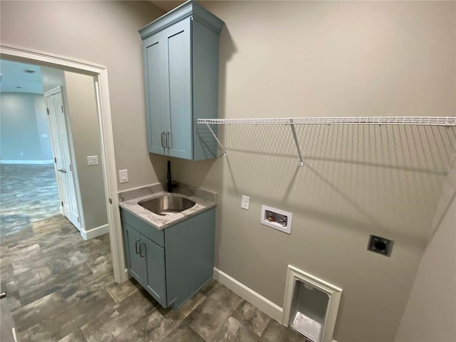 laundry area featuring cabinets, washer hookup, electric dryer hookup, sink, and dark tile flooring