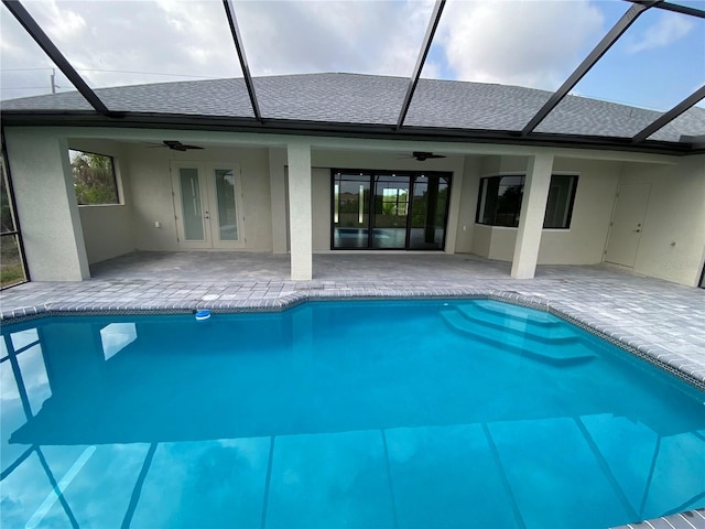 view of pool featuring a patio, a lanai, ceiling fan, and french doors