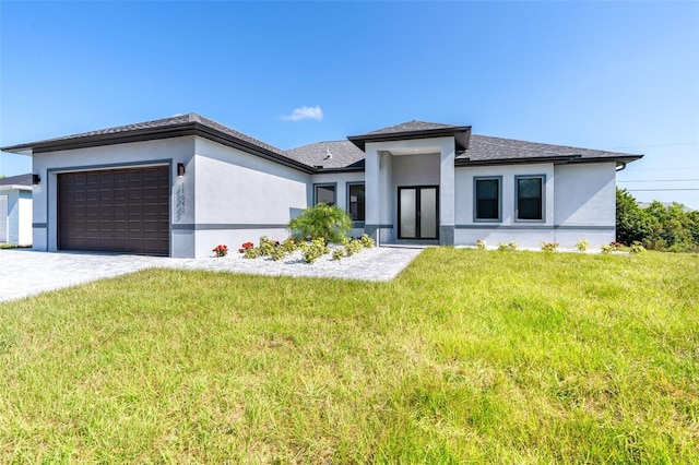 prairie-style home with a front lawn, decorative driveway, an attached garage, and stucco siding