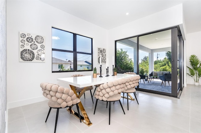 dining room featuring light tile patterned floors and baseboards