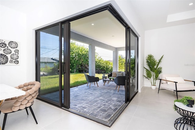 doorway to outside with recessed lighting and light tile patterned flooring