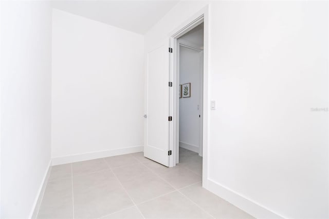 unfurnished bedroom featuring light tile patterned floors and baseboards