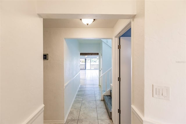 corridor featuring light tile patterned floors