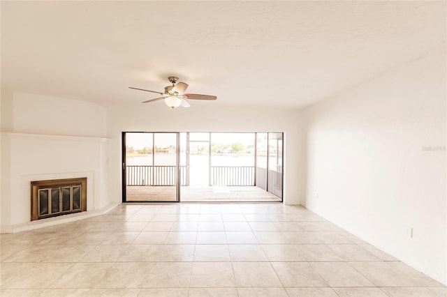 unfurnished living room with ceiling fan and light tile patterned flooring