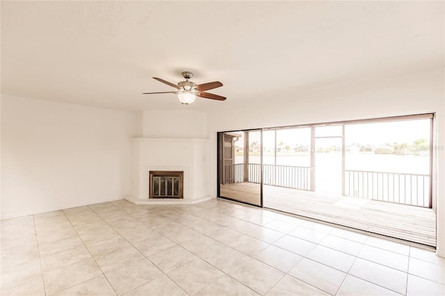 unfurnished living room with ceiling fan, plenty of natural light, and light tile patterned floors