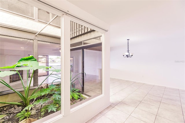 interior space with ceiling fan with notable chandelier