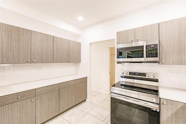 kitchen featuring stainless steel appliances, tasteful backsplash, and light tile patterned flooring