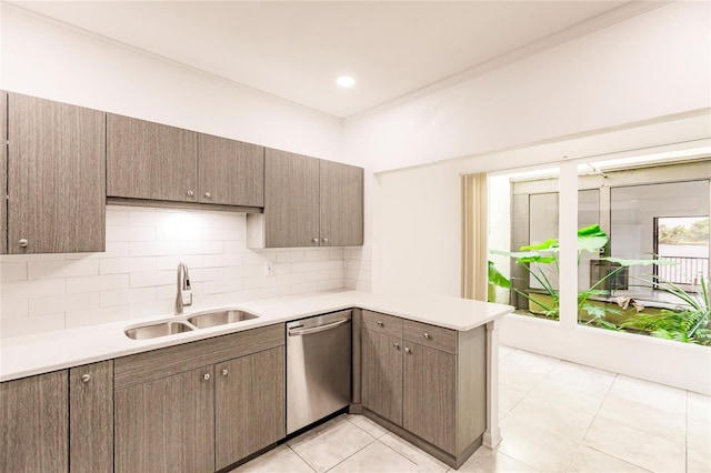 kitchen featuring kitchen peninsula, backsplash, stainless steel dishwasher, sink, and light tile patterned floors