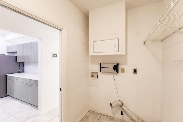 laundry room with hookup for an electric dryer, washer hookup, and light tile patterned flooring