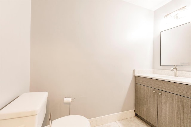 bathroom with tile patterned flooring, vanity, and toilet