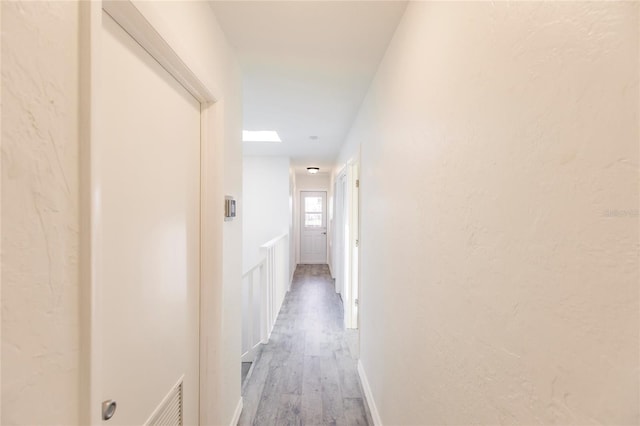 corridor featuring hardwood / wood-style flooring