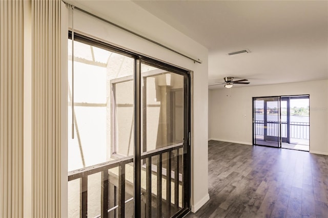 unfurnished room with ceiling fan and dark hardwood / wood-style floors