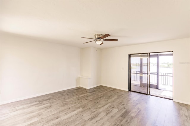 empty room with light hardwood / wood-style flooring and ceiling fan