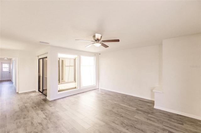 unfurnished room featuring hardwood / wood-style floors and ceiling fan