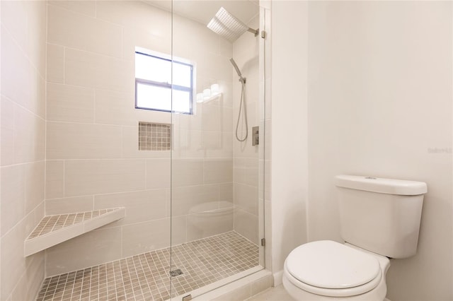 bathroom featuring an enclosed shower and toilet