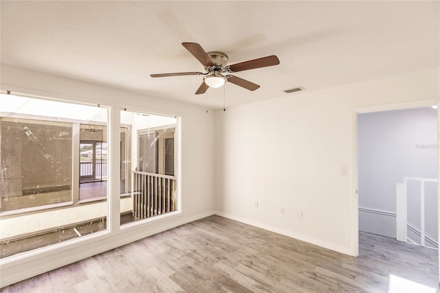 empty room with light wood-type flooring and ceiling fan