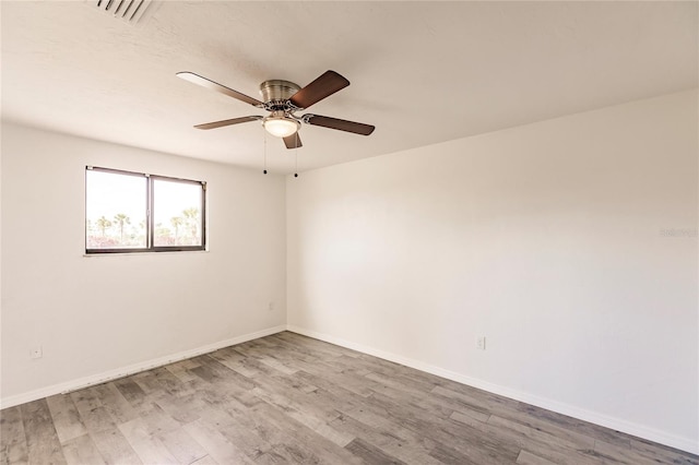 unfurnished room with hardwood / wood-style flooring and ceiling fan