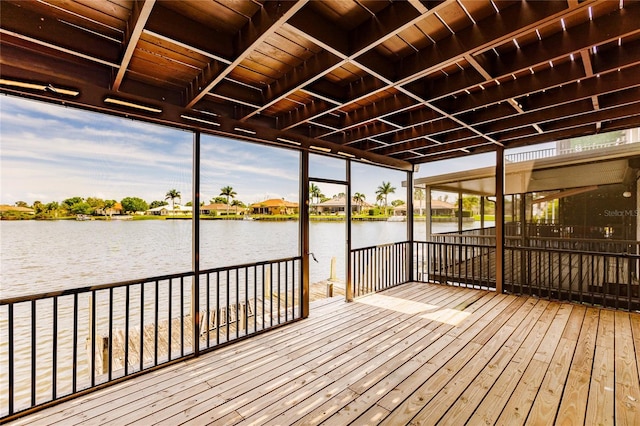 dock area featuring a deck with water view