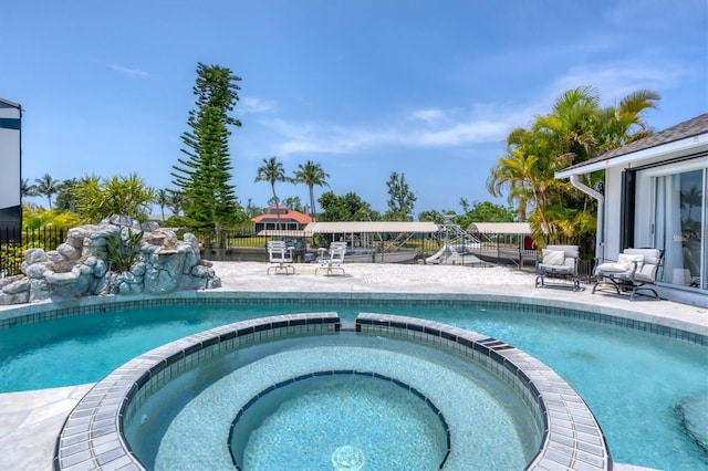 view of pool with an in ground hot tub and a patio area