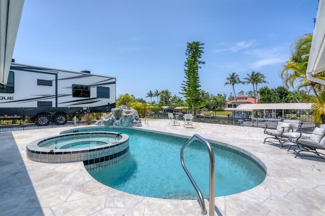 view of swimming pool featuring pool water feature, an in ground hot tub, and a patio area