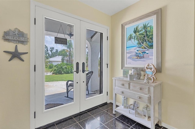 entryway featuring dark tile floors and french doors