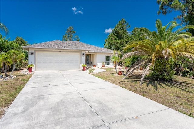 view of front of home featuring a front lawn and a garage