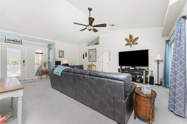 carpeted living room with ceiling fan and lofted ceiling