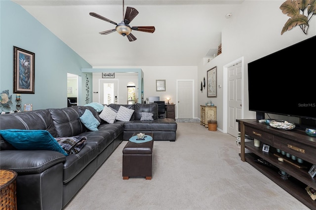 carpeted living room with high vaulted ceiling and ceiling fan